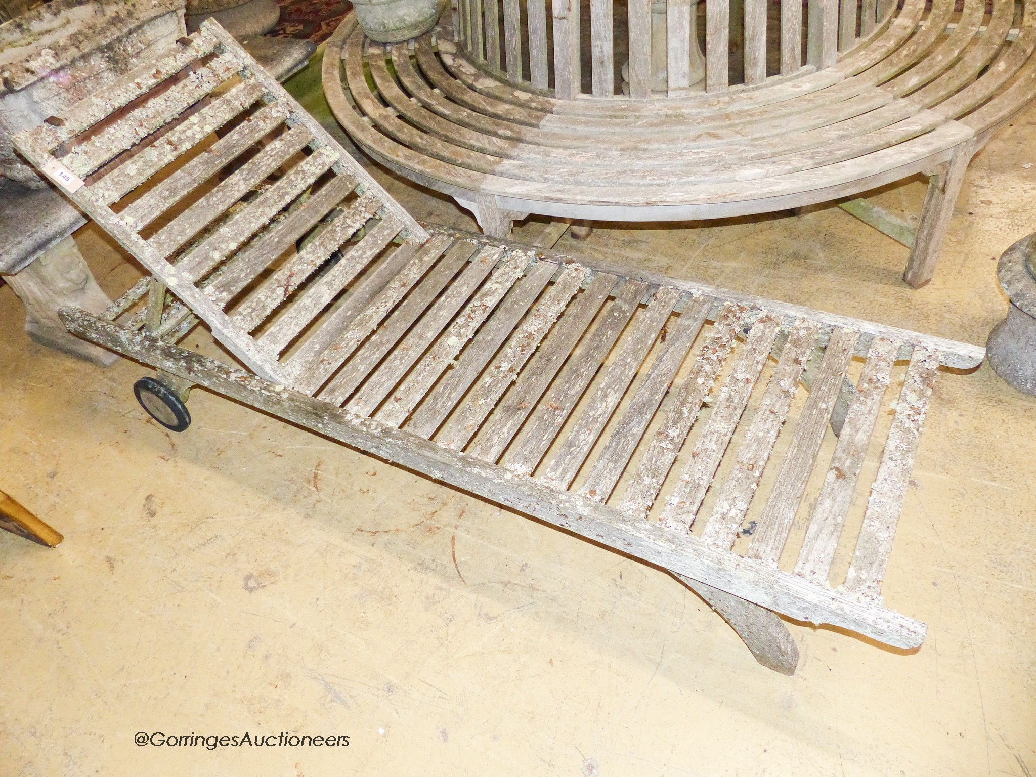 A pair of weathered teak garden loungers, length 198cm